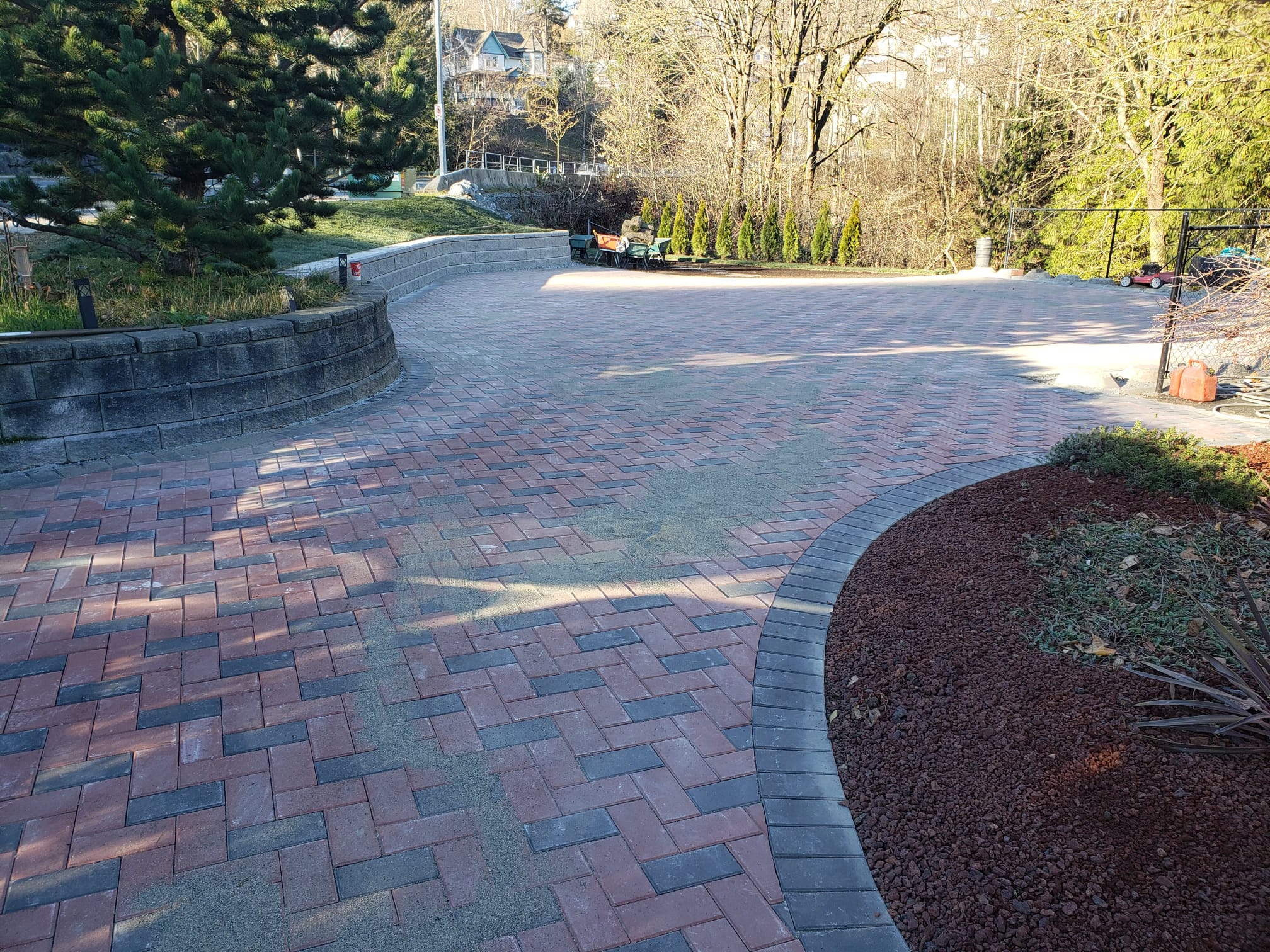 Curved red and charcoal paver driveway