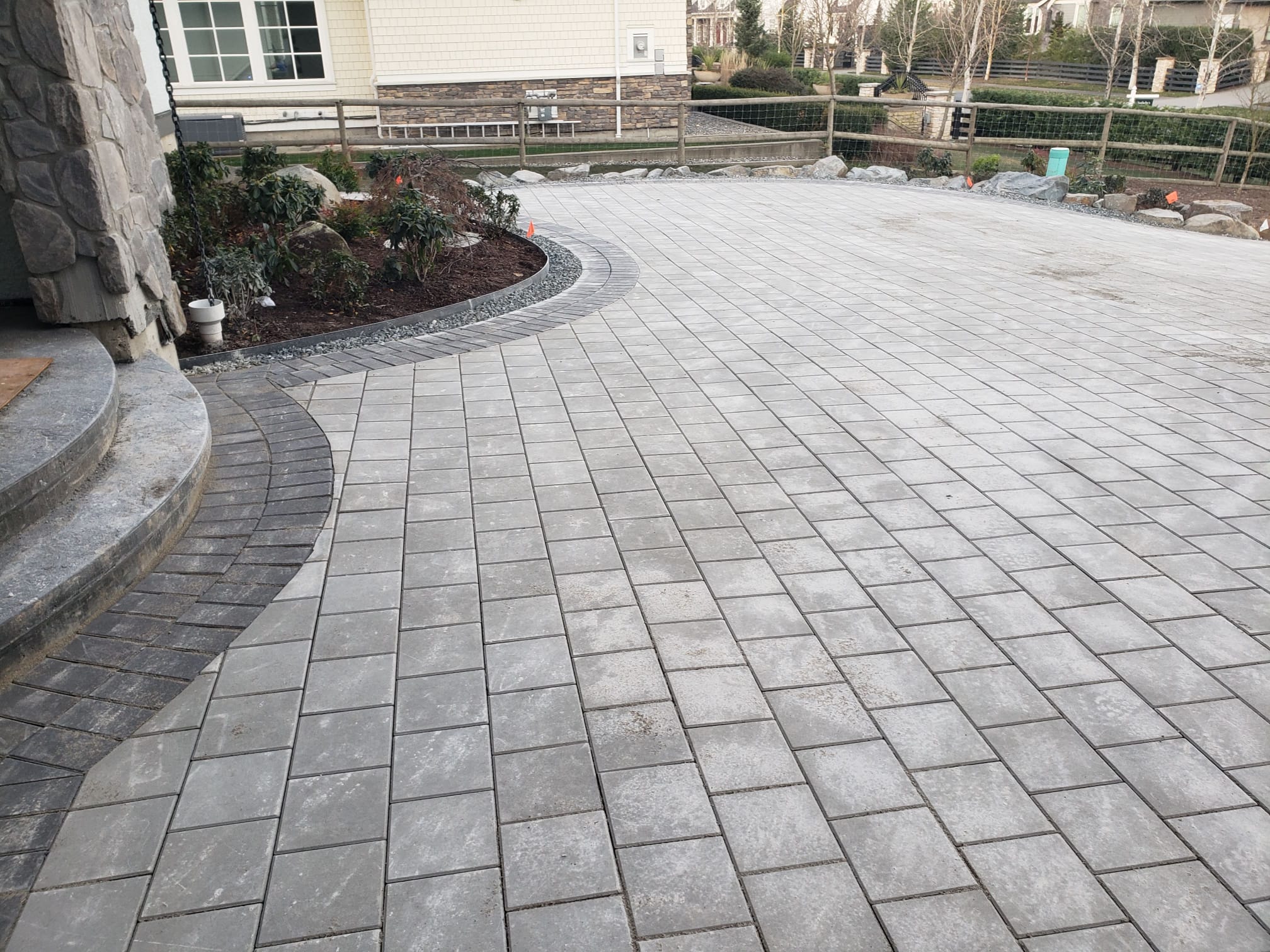 Finished custom grey paver driveway installed by DKA Landscaping